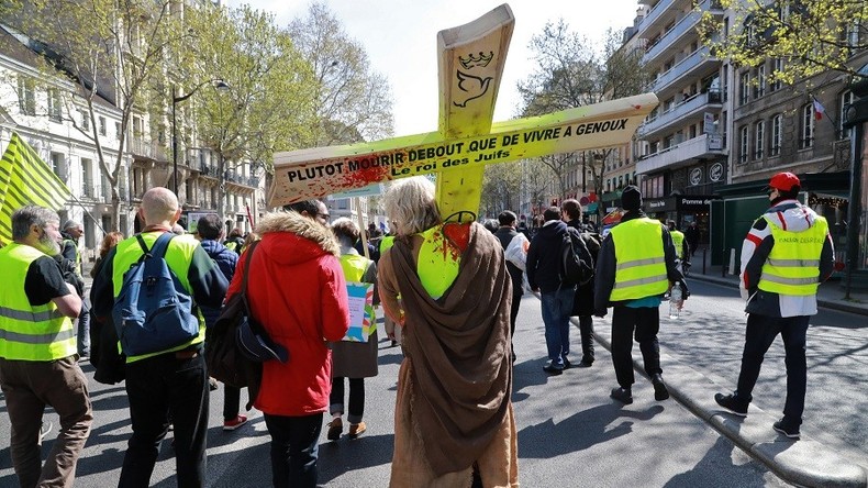 Un gilet jaune porte une croix à Paris à l'occasion de l'acte 21 de la mobilisation le 6 avril, 